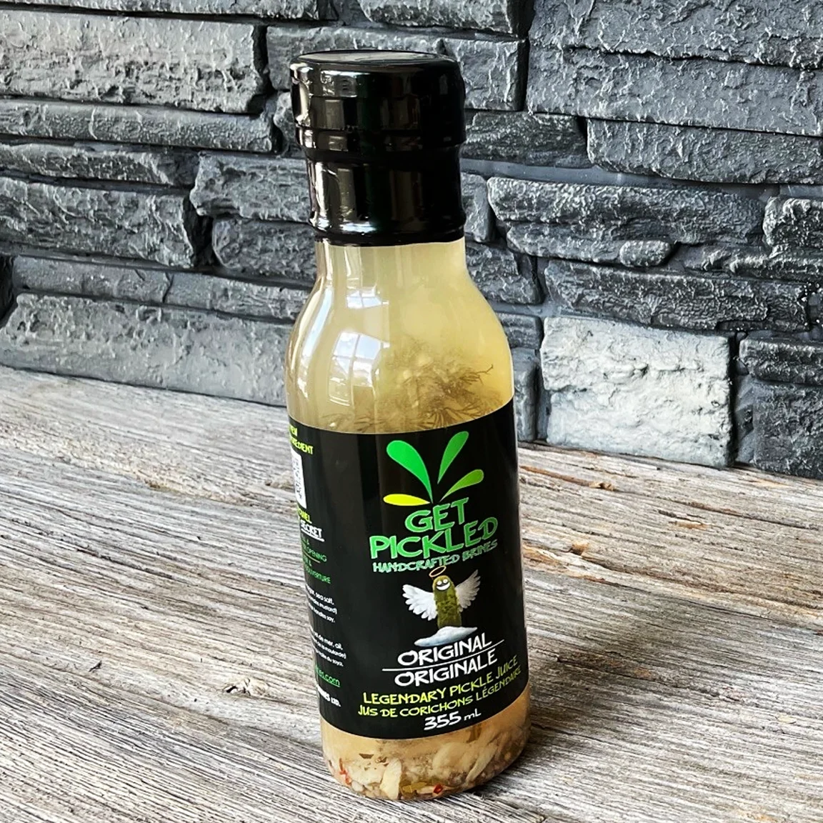 Original Get Pickled brine bottle on a wooden tabletop
